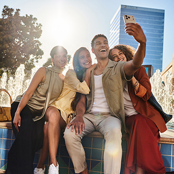 Group of friends taking a selfie near the fountain at Irvine Spectrum Center