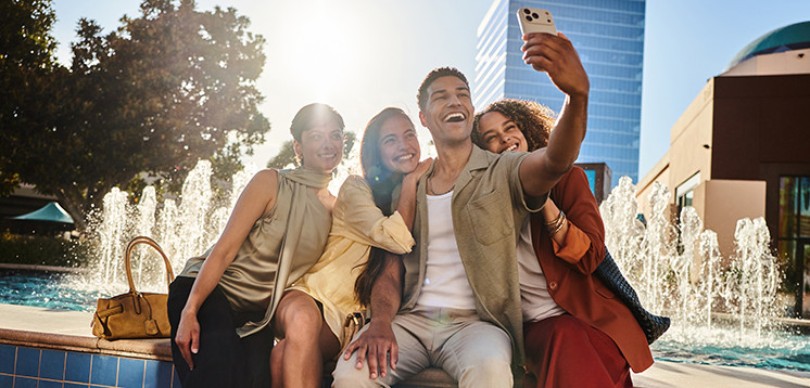 Group of friends taking a selfie near the fountain at Irvine Spectrum Center