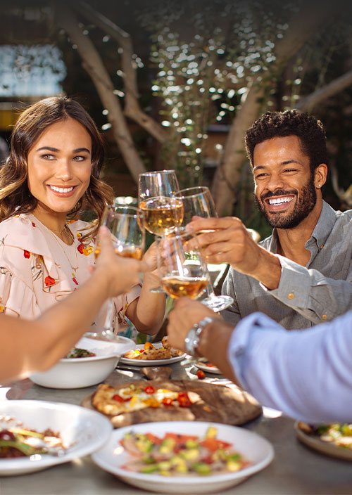 A couple smiling while eating